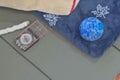 Camping mattress, and ropes flat laying background with blue blanket, leaves, globe, hiking compass and camping gear on green