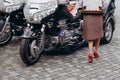 Girl`s beautiful legs on a background of motorcycle Gold Wing. Biker meeting, camping