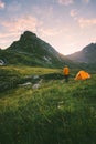 Camping in mountains man alone enjoying sunset landscape Royalty Free Stock Photo