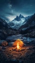 Camping in the mountains near a glowing campfire. Royalty Free Stock Photo