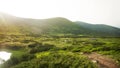 Camping near Lake Nesamovite in the green valley of the Carpathians, landscape overlooking the camp with many tents on sunset Royalty Free Stock Photo