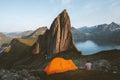 Camping in Norway man traveler relaxing in mountains with tent