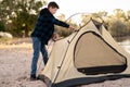 Camping people outdoor lifestyle tourists, summer river. boy installing tent. Natural children