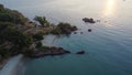 Camping on shore under the trees with beautiful sun light in the morning, the beach with rocks and blue water, Outdoor lifestyle Royalty Free Stock Photo