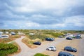 Camping site with big car parking space called `Kogerstrand` in the dunes near beach
