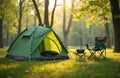 Camping site forest meadow in spring. Green tent with camp chair on green grass. Nature background. Rest in forest with folding Royalty Free Stock Photo