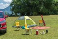 Camping site on grass field with tent and car beside tent. Leisure activity Royalty Free Stock Photo