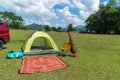 Camping site on grass field with tent and car beside tent. Leisure activity Royalty Free Stock Photo