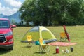 Camping site on grass field with tent and car beside tent. Leisure activity Royalty Free Stock Photo