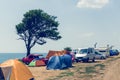 Camping site near the sea, cars and tents on the sea beach