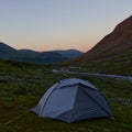 Camping in a stunning valley of the Abisko national park, along the Kungsleden. The sun is just setting behind the horizon.