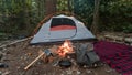 Camping tent in the Blue Ridge Mountains in Asheville, North Carolina. Outdoor lifestyle with axe, cast iron skillet, flannel blan Royalty Free Stock Photo