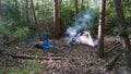 Camping tent in the Blue Ridge Mountains in Asheville, North Carolina. Outdoor lifestyle with axe, cast iron skillet, flannel blan Royalty Free Stock Photo