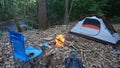 Camping tent in the Blue Ridge Mountains in Asheville, North Carolina. Outdoor lifestyle with axe, cast iron skillet, flannel blan Royalty Free Stock Photo