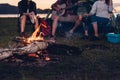 Camping tent camp in nature happy friends group night party bonfire and playing guitar together Royalty Free Stock Photo