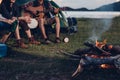 Camping tent camp in nature happy friends group night party bonfire and playing guitar together Royalty Free Stock Photo