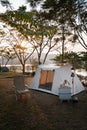 Camping tent on campsite with panoramic view in evening sunset. cozy tents for recreation near lake. people outdoors activity camp Royalty Free Stock Photo