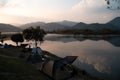 Camping tent on campsite with panoramic view in evening sunset. cozy tents for recreation near lake. people outdoors activity