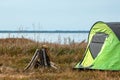 Camping tent green in the background of nature and lake. The concept of travel, tourism, camping