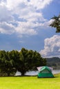 Camp and tent on green grass field under clear sky Royalty Free Stock Photo