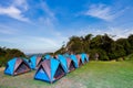 Camping tent on green grass field under clear sky Royalty Free Stock Photo