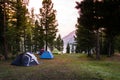 Camping tent on green grass beside lake with foggy Royalty Free Stock Photo