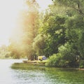 Camping tent near a beautiful lake, summer campsite, family vacation concept