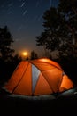 Camping Tent Under Star Trails And Rising Moon