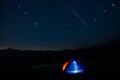 Camping tent under stars at night