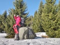 Camping in tent in winter forest. Snowshoes trek in mountains