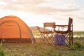 Camping tents, camp tent and chair by the river at sunset in the summer. Lifestyle concept and camping holiday