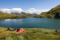 Camping tents on capra lake in fagaras mountains romania Royalty Free Stock Photo