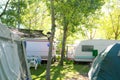 Camping tents caravan in green trees outdoor