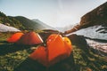 Camping tents in mountains morning sun landscape