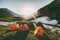 Camping tents in mountains morning sun landscape