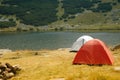 Camping tents near a mountain lake Royalty Free Stock Photo