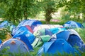 Camping, tents and outdoor music festival in park on holiday or vacation in summer forest. Camp, site and shelter setup