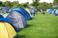 Camping, tents and outdoor music festival in park with people on field with grass or trees in summer. Camp, site and Royalty Free Stock Photo