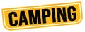 CAMPING text written on yellow-black stamp sign