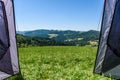 Camping tourist tent set up on meadow in the mountains. Small tent in green mountains of Slovenia