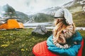 Camping travel vacations woman relaxing in sleeping bag on mat