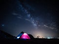 Camping under the stars in the mountains and tents with light. Royalty Free Stock Photo