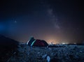 Camping under the stars in the mountains and tents with light. Royalty Free Stock Photo