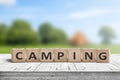 Camping word on a wooden cube sign