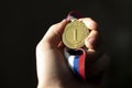 campion& x27;s hand holding a golden medal, simple winner lucky concept Royalty Free Stock Photo