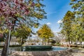 Street lamp with unfocused flower branches, fountain and bandstand in the background in the garden, Ponte de Sor PORTUGAL