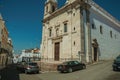 Church marble facade in front of street with old houses