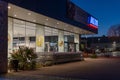 Image of the parking lot and the blue and red luminous sign of a Aldi supermarket chain