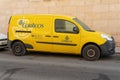 Yellow mail delivery truck parked on a street