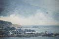 CAMPS BAY, CAPE TOWN, 13 October 2017 - Helicopters fight Camps Bay fire fanned by strong westerly winds. Royalty Free Stock Photo